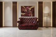 Luxurious red leather sofa in a stylish room with marble floor and abstract art on the wall.