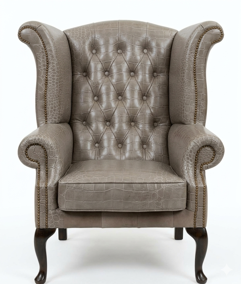 Gray upholstered wingback chair with buttoned backrest on a white background