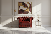 Red leather armchair in a stylish room with abstract art and marble floor.