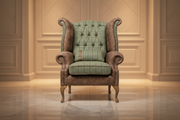 Vintage-style armchair with brown and green plaid fabric on a white background
